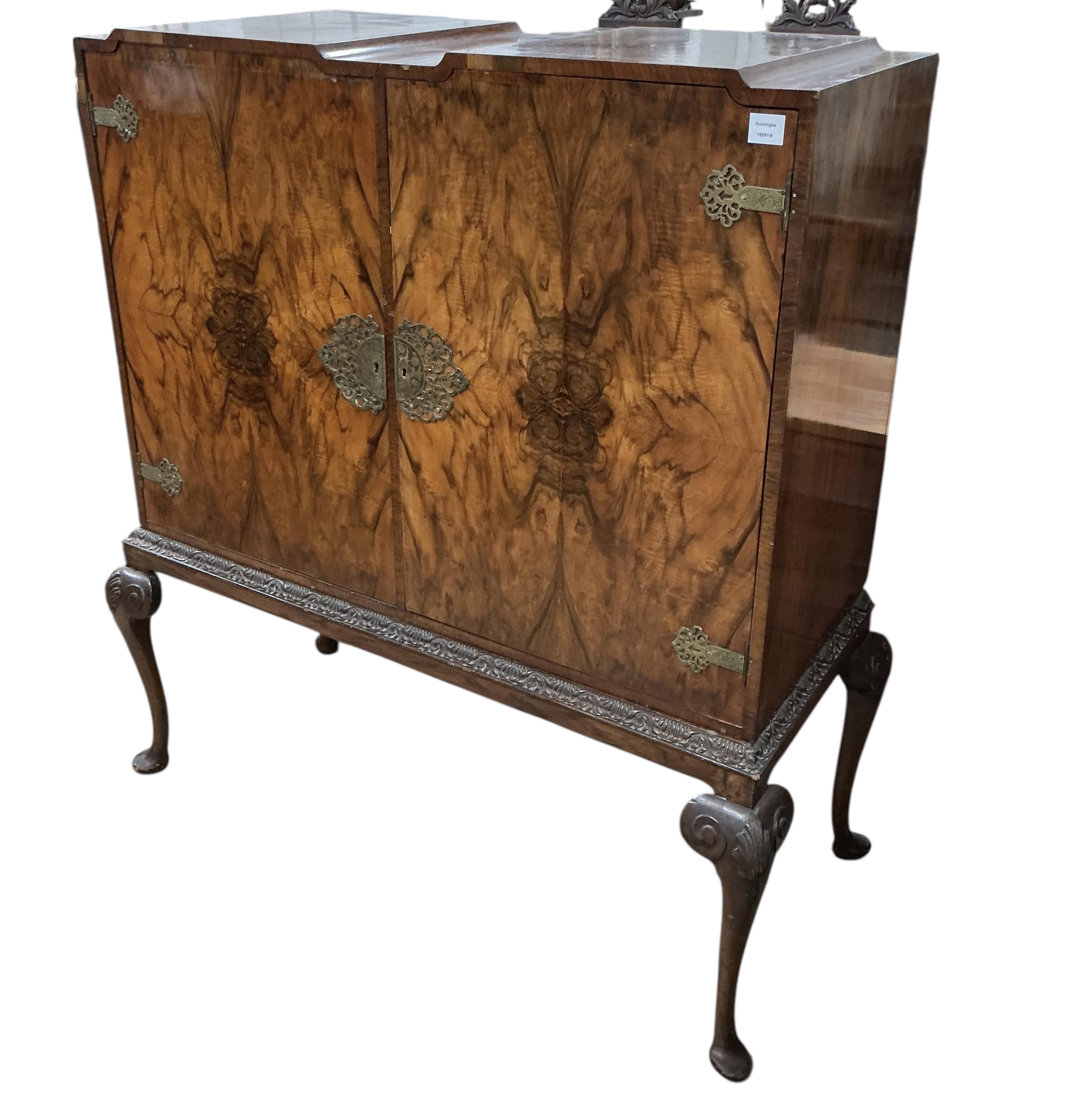 A Queen Anne Revival walnut side cabinet, width 128cm, depth 56cm, height 140cm
